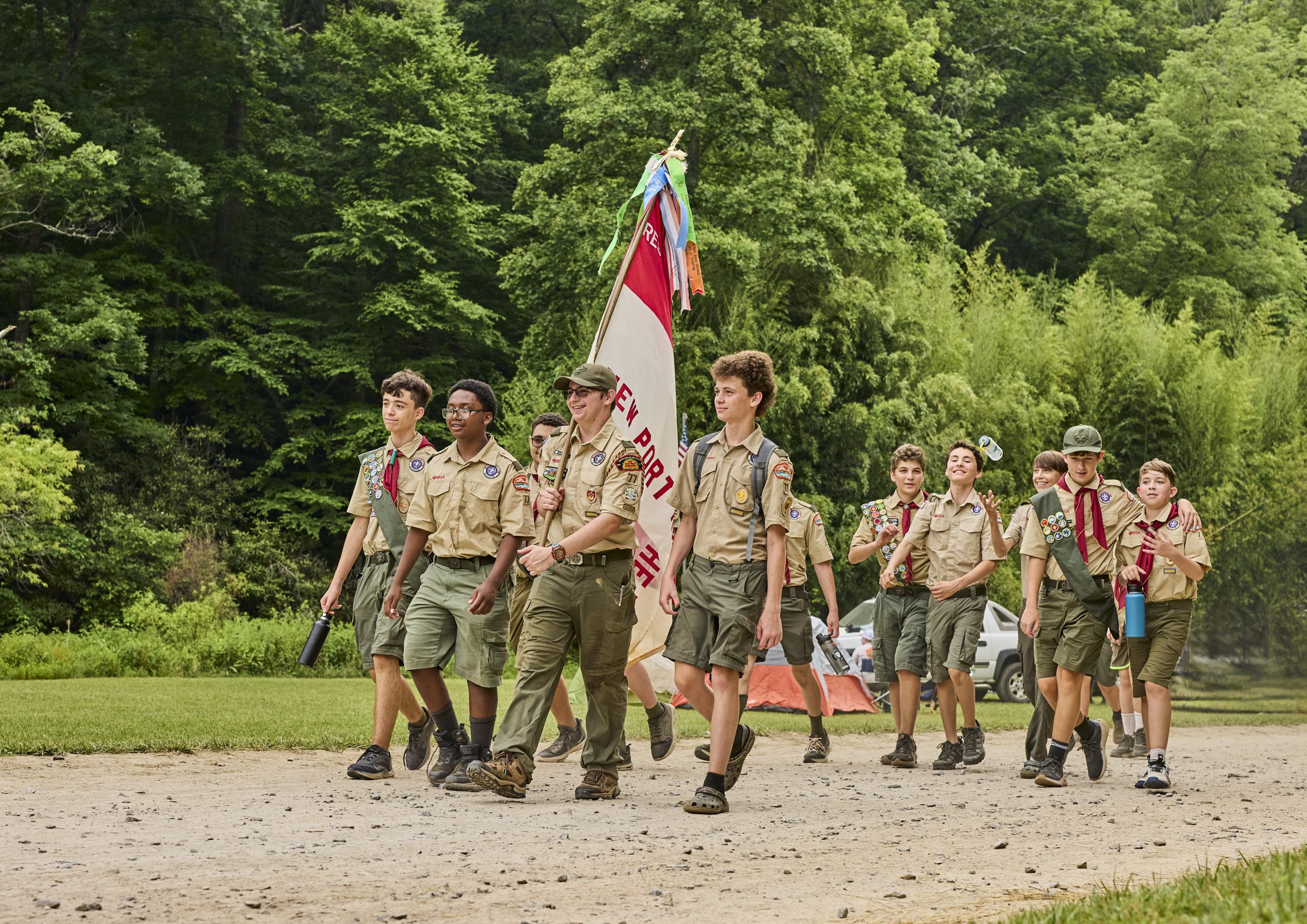 Scouts BSA photo 2024 - Walking on trail with troop flag