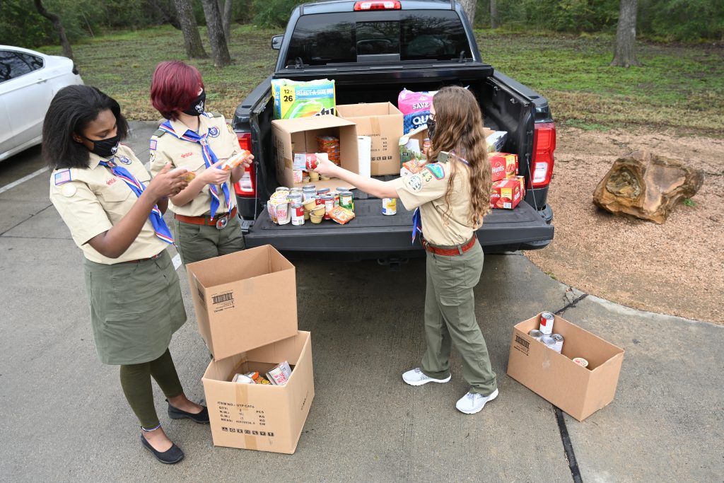 Be the Change Event - Masks / Face Coverings / Covid-19 / Pandemic Safety Unloading a truck with food for Scouting for Food